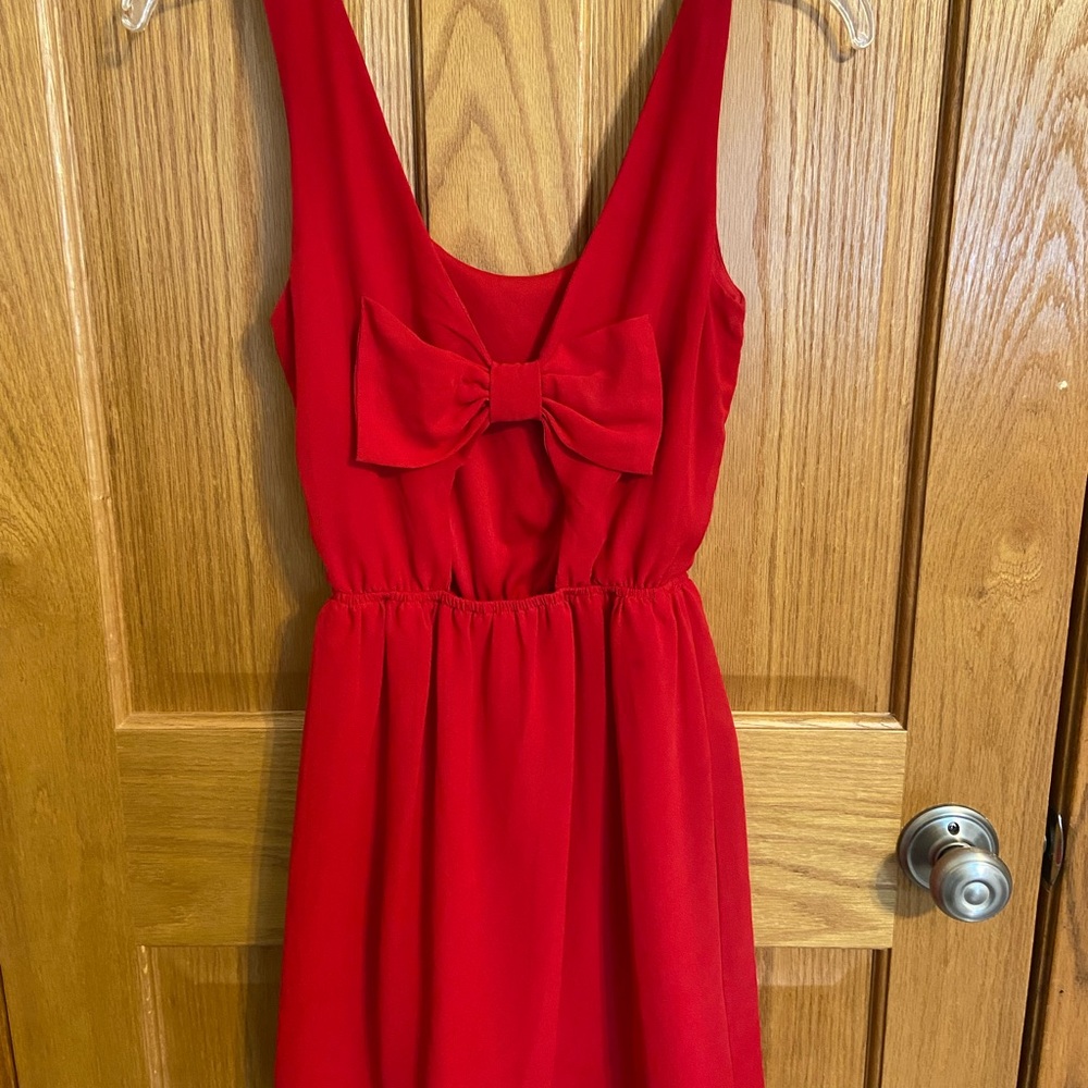 Adorable short red dress with bow and open back